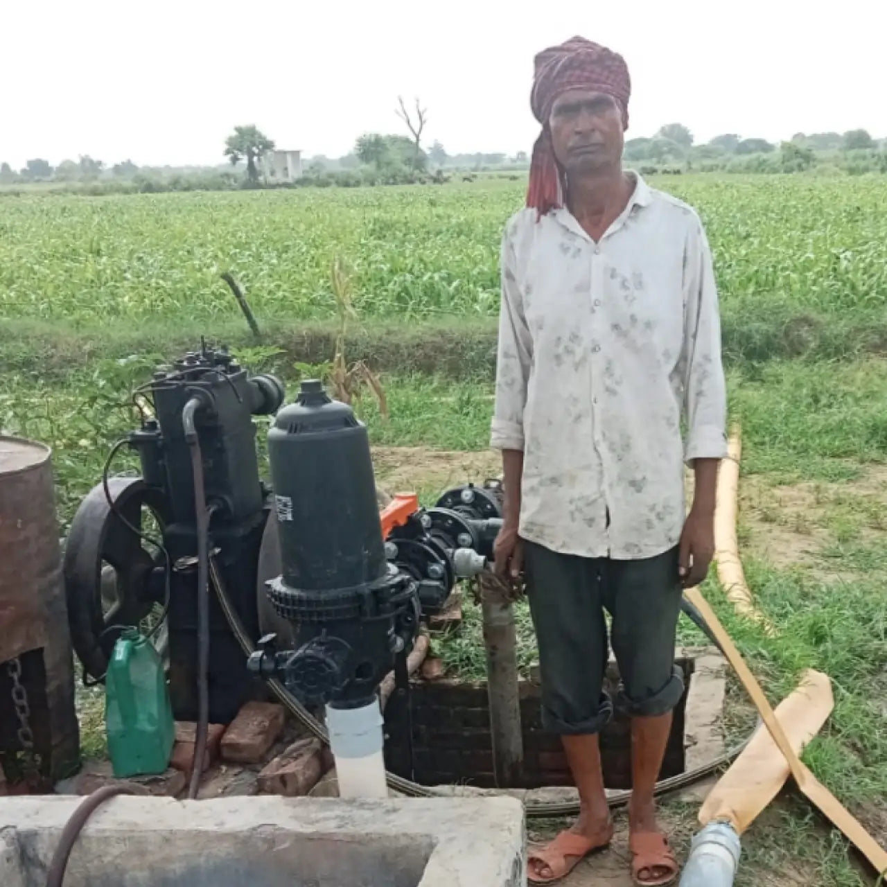 Man standing next to a water pump in a field using dripshakti screen filter
