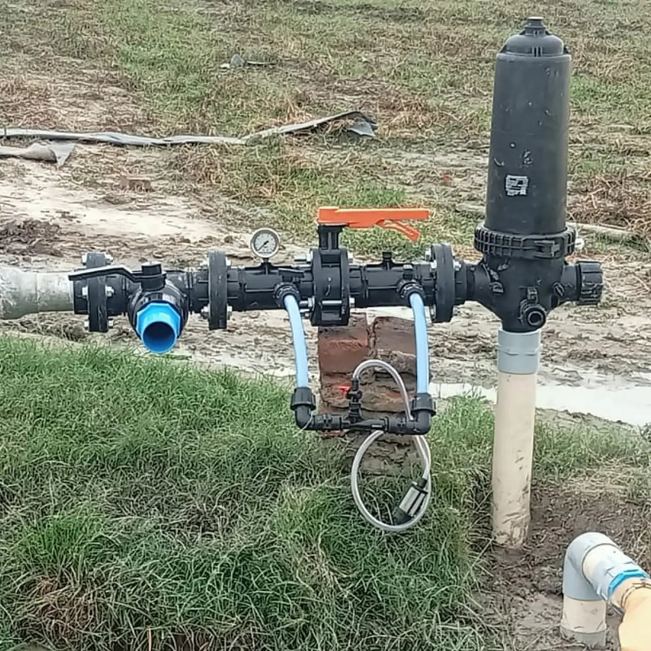 screen filter use Pump system with pipes and valves on a grassy field